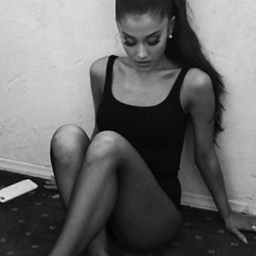 Ariana Grande shows nice legs in black lingerie