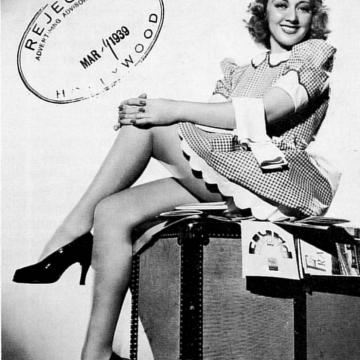 Joan Blondell shows sexy legs